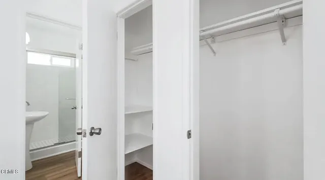 a view of closet with bathroom