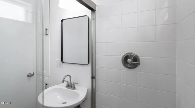a bathroom with a sink and mirror
