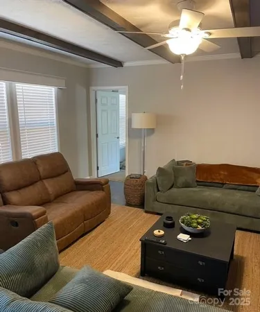 a living room with furniture and a ceiling fan