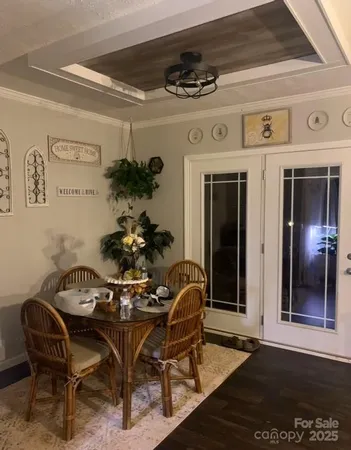 a view of a dining room with furniture and chandelier