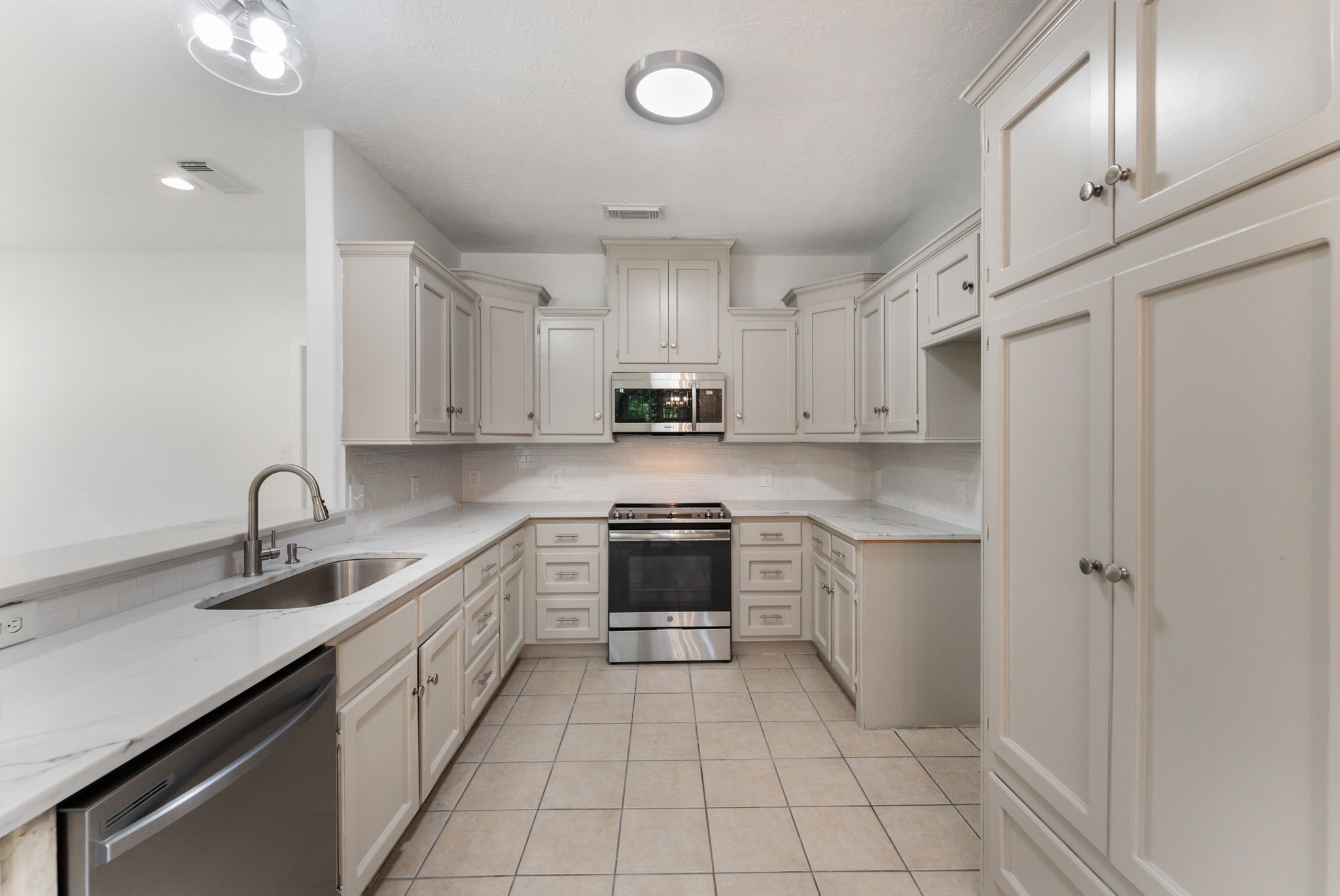 92 Tupelo Lane Conroe, TX 77304 - Photo 1 of 21 a kitchen with a sink appliances and cabinets