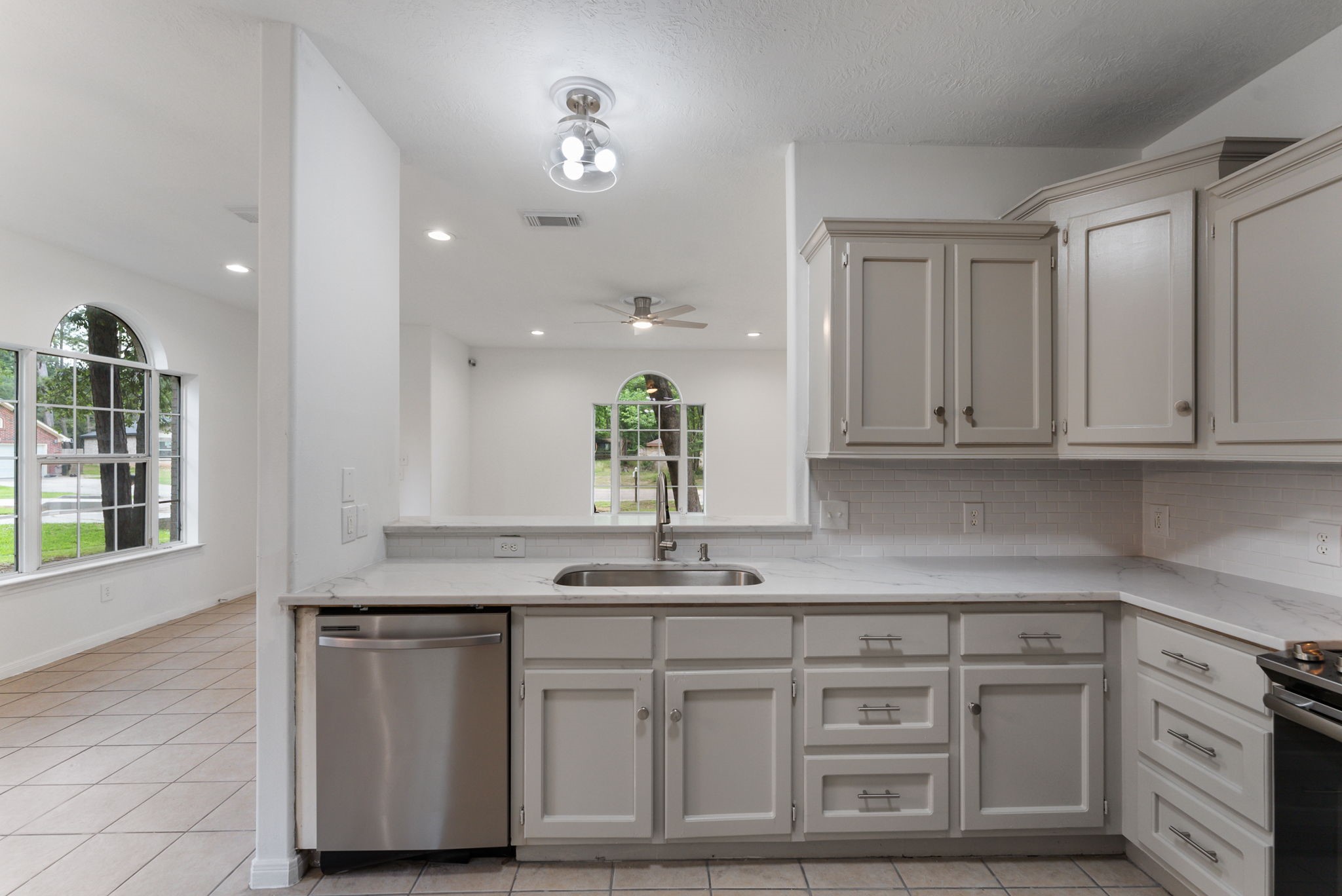 92 Tupelo Lane Conroe, TX 77304 - Photo 12 of 21 a kitchen with stainless steel appliances granite countertop a sink and a white cabinets