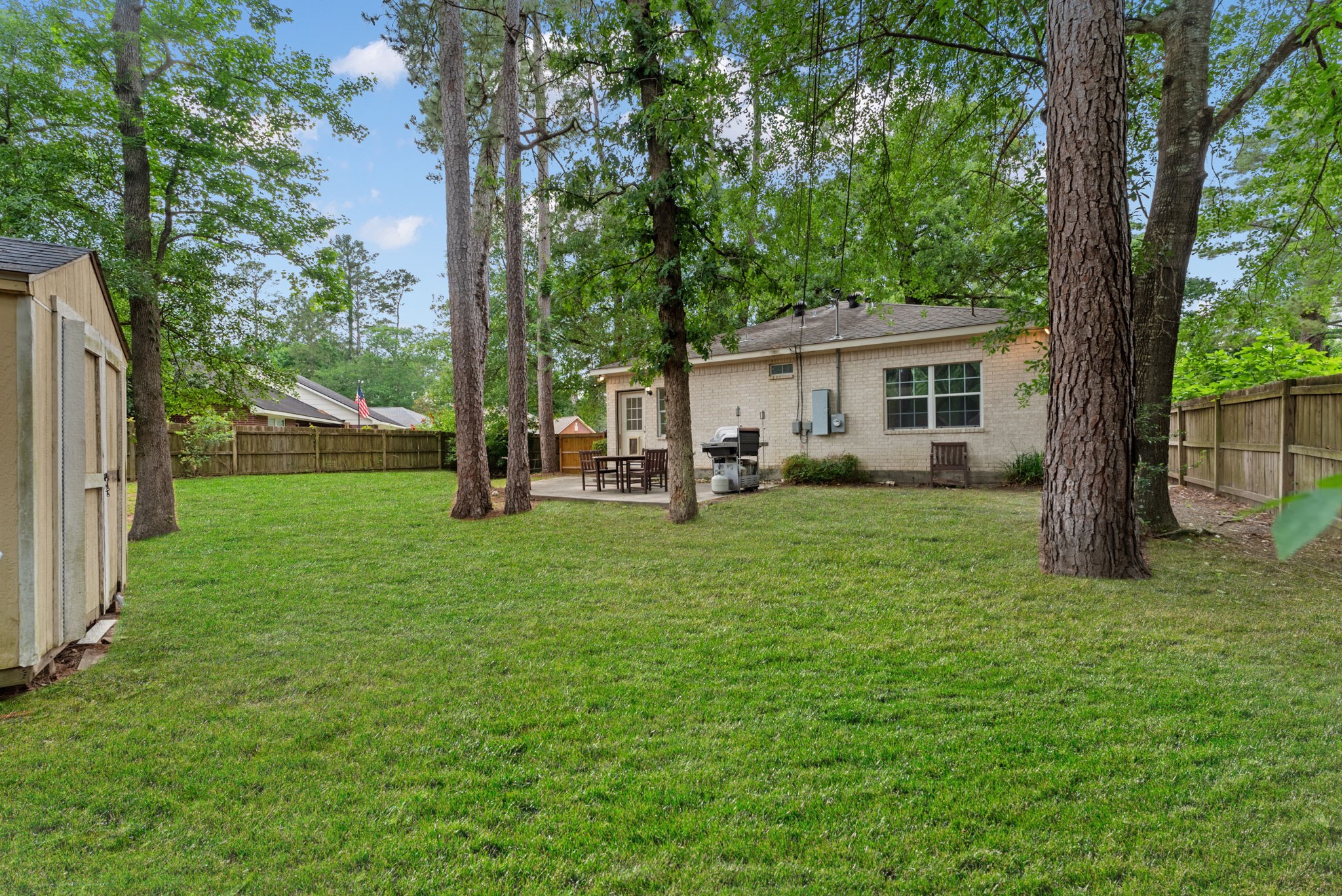 92 Tupelo Lane Conroe, TX 77304 - Photo 19 of 21 a view of a house with backyard and a tree