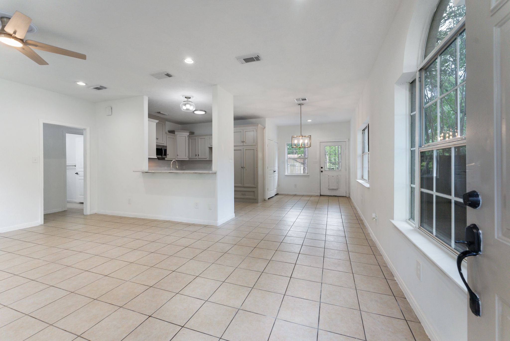 92 Tupelo Lane Conroe, TX 77304 - Photo 10 of 21 a view of a hallway with wooden floor and a kitchen