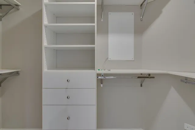 a white bath tub sitting next to a shower