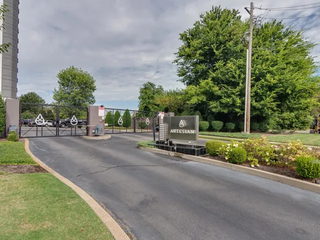 a view of a street with a bench and trees