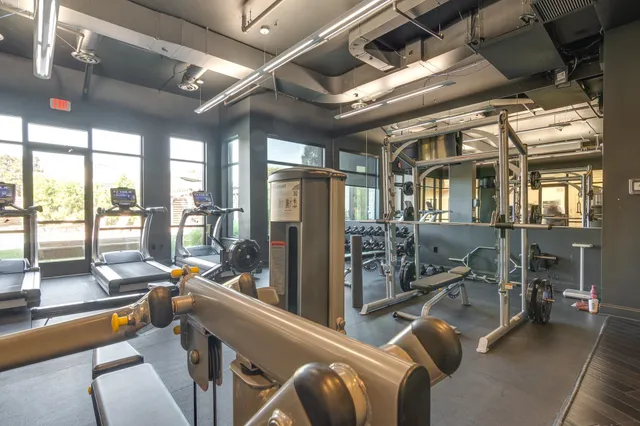 a room with gym equipment and floor to ceiling window