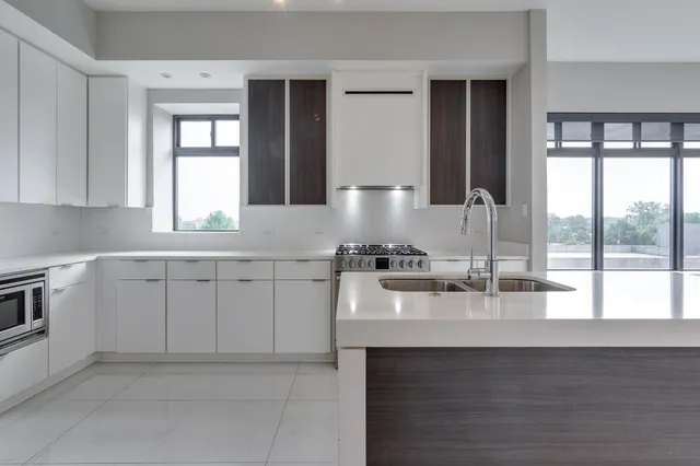 a kitchen with sink cabinets and window
