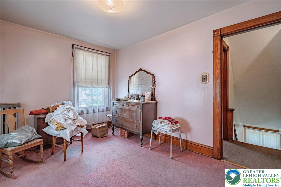 159 West Ridge Street Nesquehoning, PA 18240 - Photo 26 of 55 Soft pink hues envelop this cozy bedroom, offering a serene retreat with a naturally lit window.