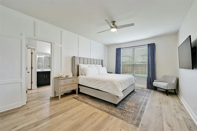 a bedroom with a bed and a large window