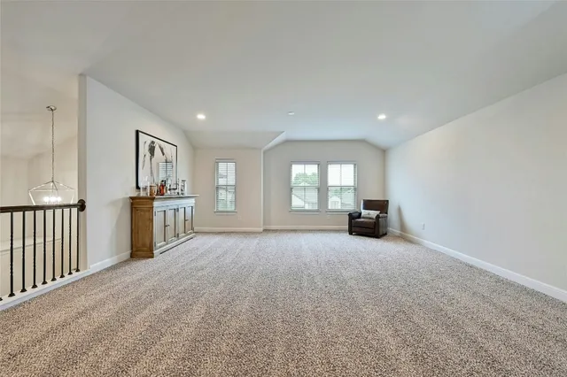 a view of empty room with windows and fireplace