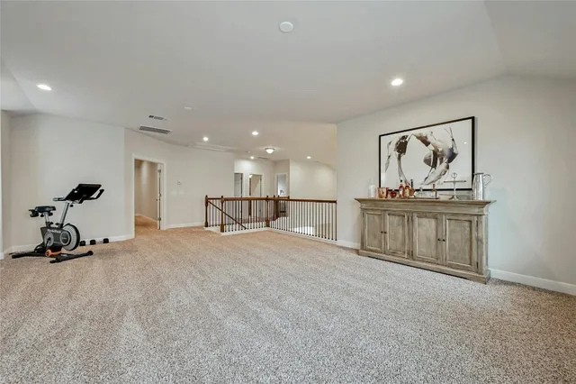 a view of a room with gym equipment and a large window