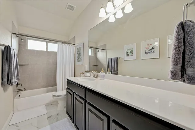 a bathroom with a sink a large mirror and a bathtub