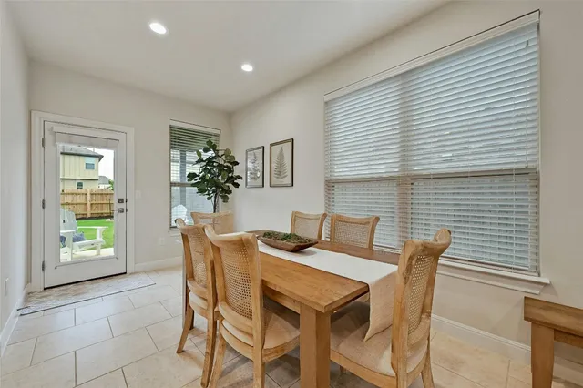 a dining room with furniture and window