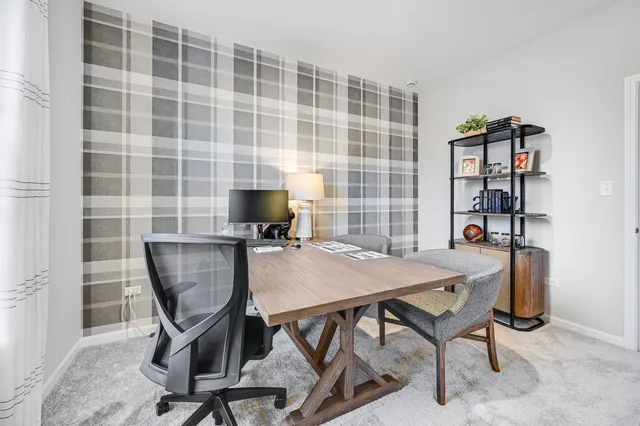 a view of a workspace with furniture and a bookshelf