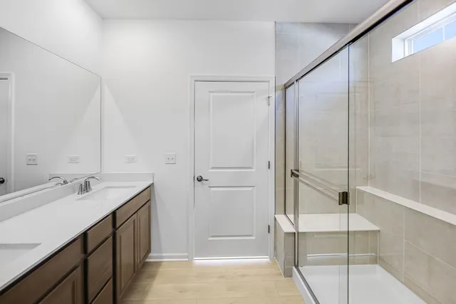 a bathroom with a shower and a sink