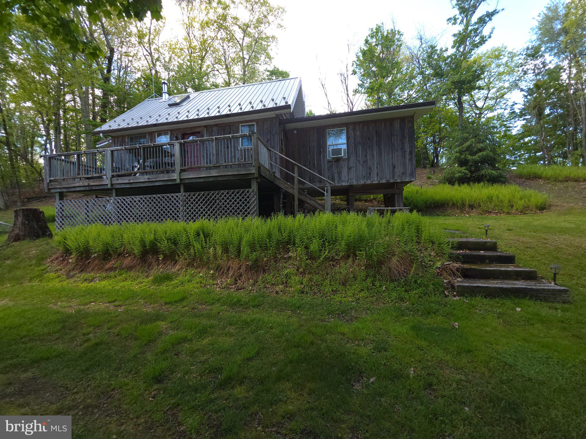 152 Sharp Ridge Lane Franklin, WV 26807 - Photo 3 of 53 a view of a house with a backyard and sitting area