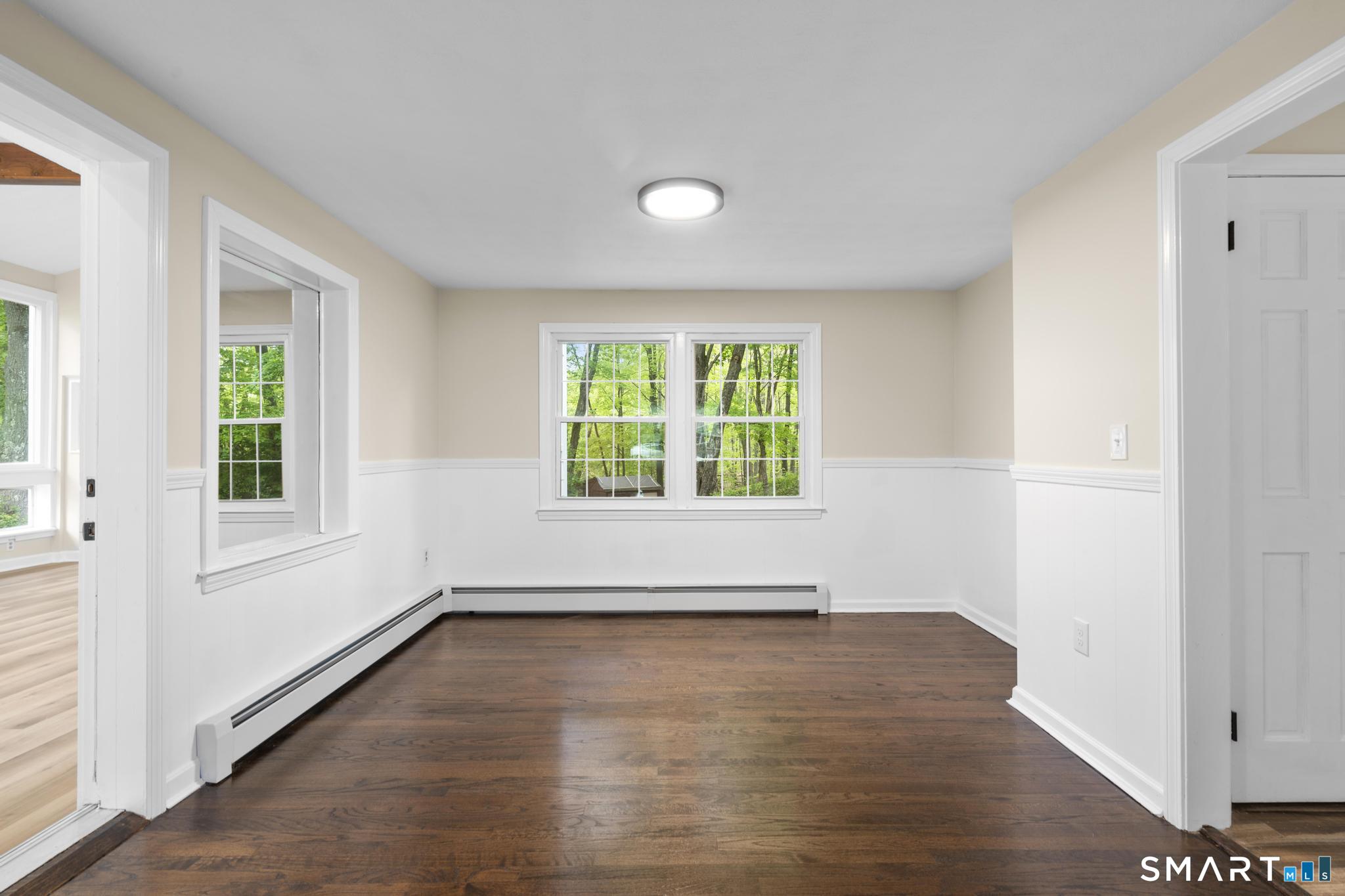 7 Sycamore Terrace Windham, CT 06280 - Photo 7 of 40 an empty room with wooden floor and windows