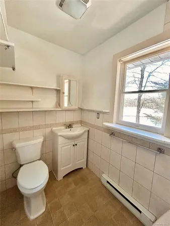a bathroom with a bathtub and next to a window