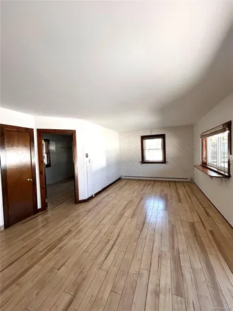 a view of wooden floor and windows in a room