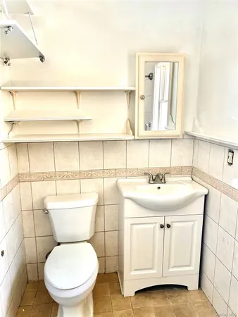 a bathroom with a toilet sink and window