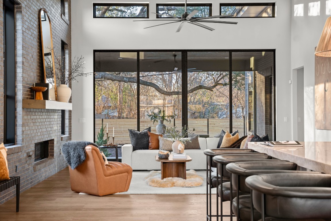 7706 Rutgers Avenue Austin, TX 78757 - Photo 19 of 35 a living room with fireplace furniture and a floor to ceiling window