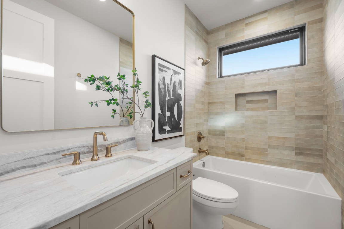 7706 Rutgers Avenue Austin, TX 78757 - Photo 31 of 35 a bathroom with a sink a toilet and shower