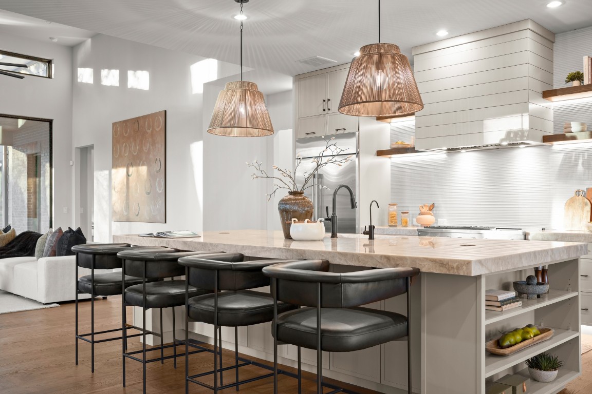 7706 Rutgers Avenue Austin, TX 78757 - Photo 7 of 35 a kitchen with stainless steel appliances granite countertop a stove a sink a dining table and chairs with wooden floor