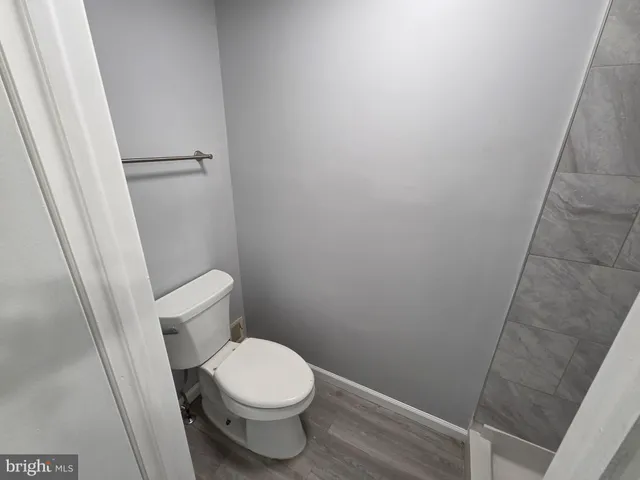 a white toilet sitting next to a shower