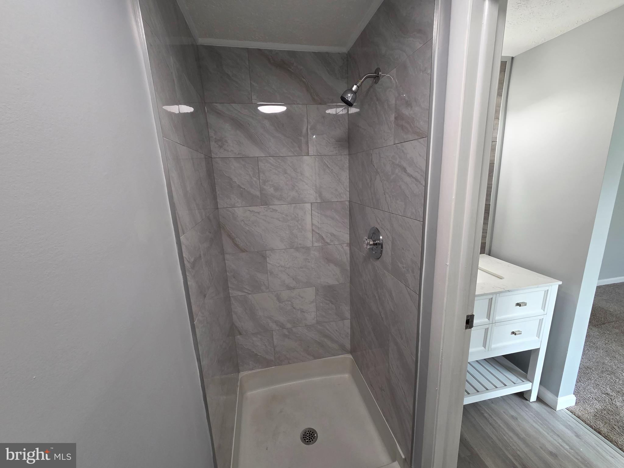 17923 Ashton Club Way Ashton, MD 20861 - Photo 13 of 21 a bathroom with a tub shower vanity and a sink