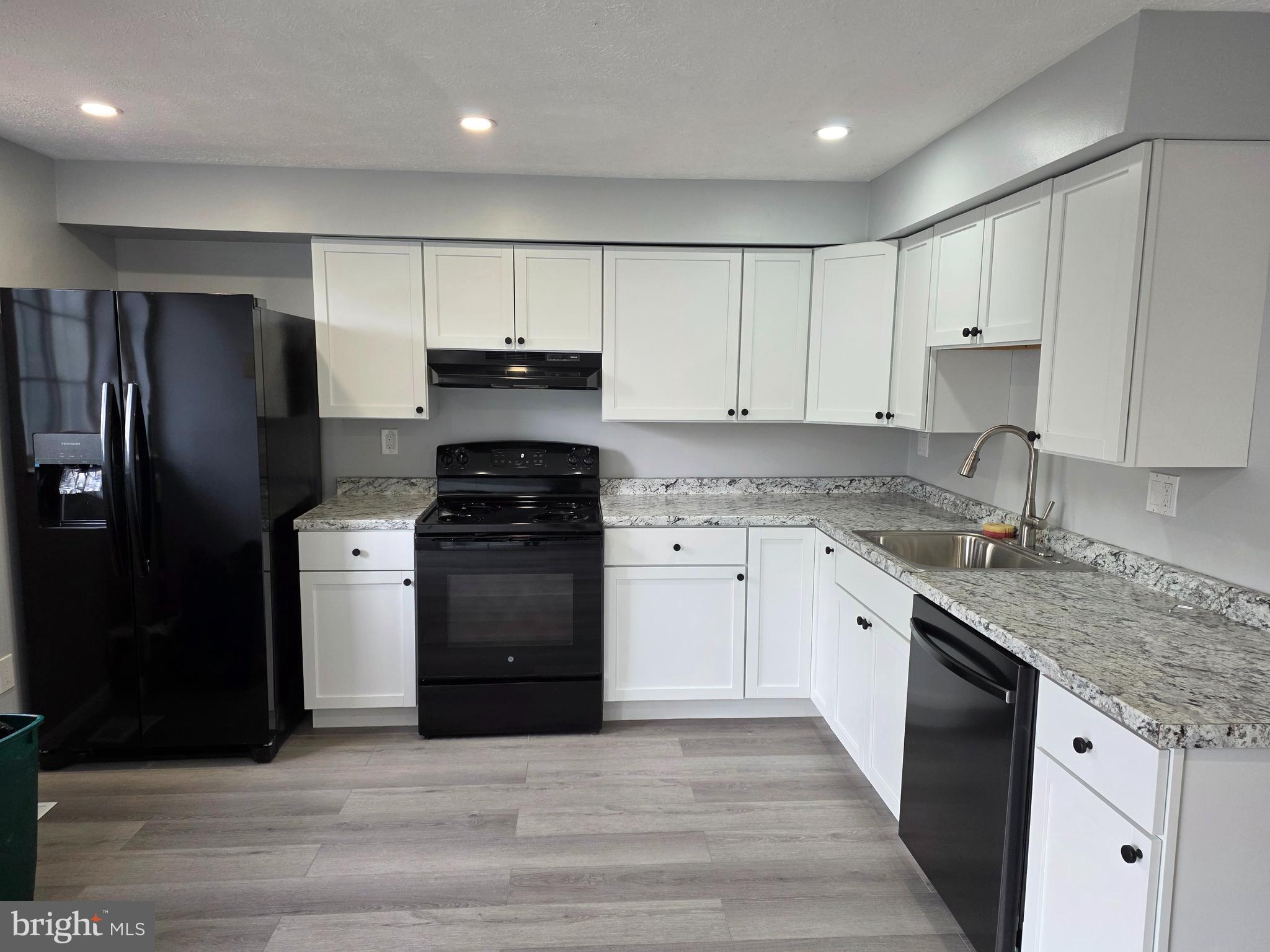 17923 Ashton Club Way Ashton, MD 20861 - Photo 5 of 21 a kitchen with granite countertop a refrigerator stove and sink