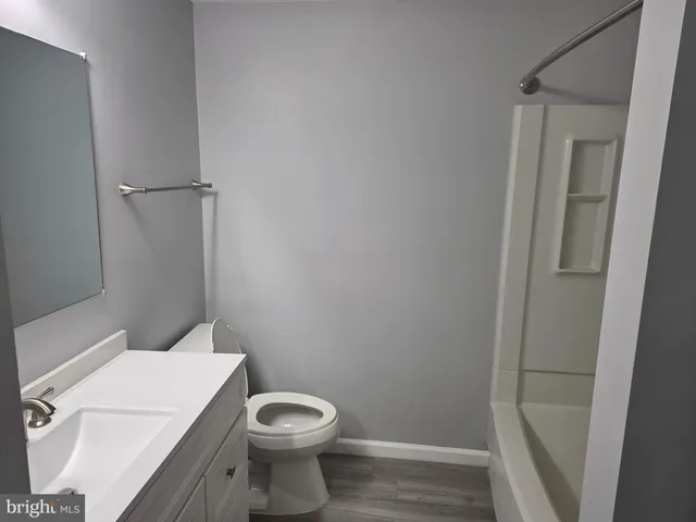 a white toilet sitting next to a shower