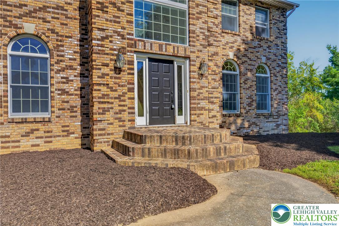 630 Clearfield Road Nazareth, PA 18064 - Photo 15 of 100 An inviting brick entryway with arched multi-pane windows leads into the home.