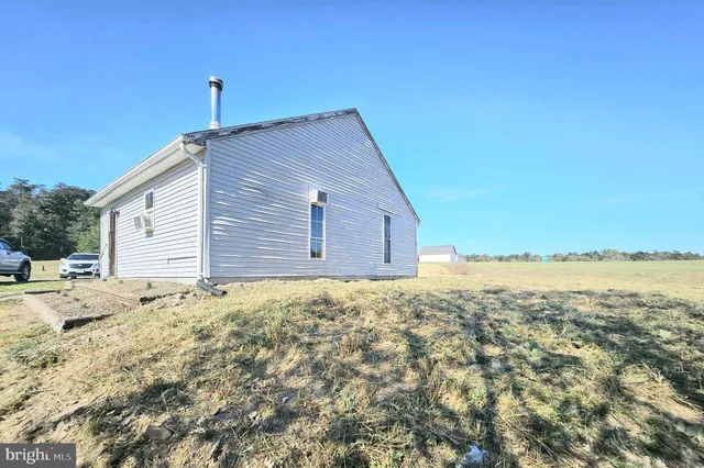 a large bedroom with table and chairs