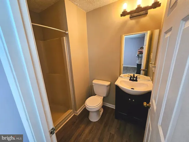 a kitchen with wooden floors and a sink