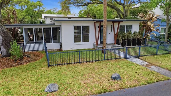 a view of a house with a backyard and porch
