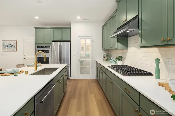 a kitchen with a sink cabinets and appliances