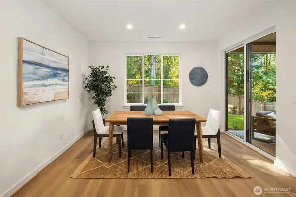 a living room with furniture a large window and a fireplace
