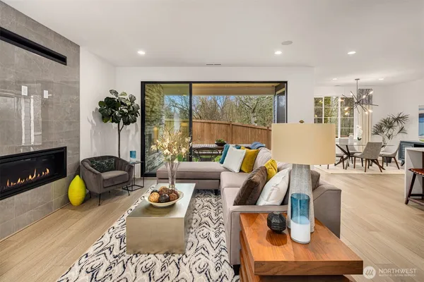 a view of a kitchen with kitchen island a large window a sink and living room view