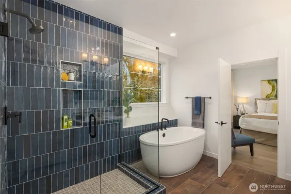 a spacious en suite bathroom with a granite countertop tub and a sink