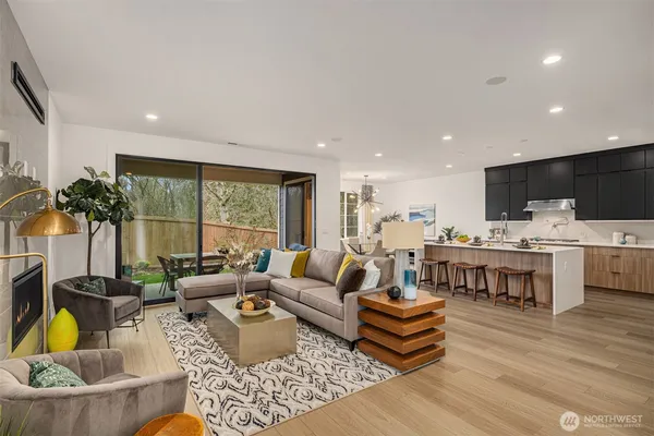 a kitchen with a table chairs sink and cabinets