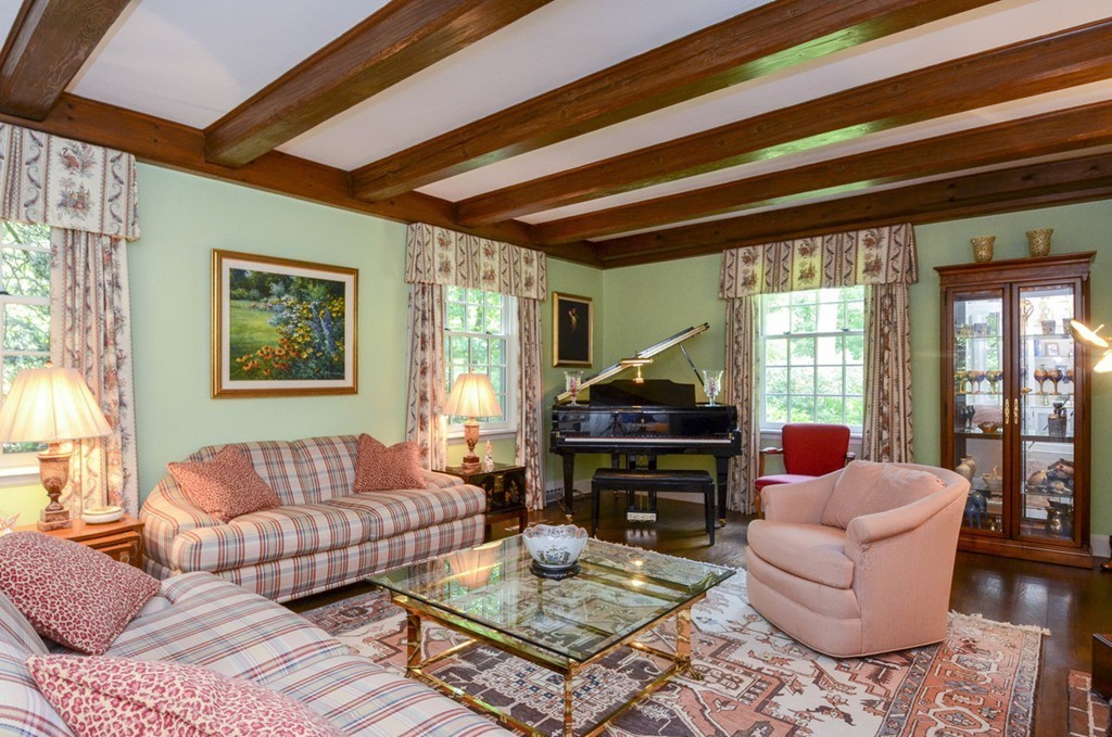 129 Overbrook Road Longmeadow, MA 01106 - Photo 4 of 30 a living room with furniture a flat screen tv and a floor to ceiling window