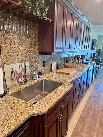 a kitchen with granite countertop stainless steel appliances window a sink and a counter space