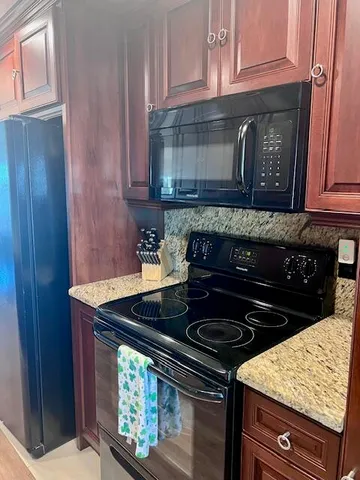 a stove top oven sitting inside of a kitchen