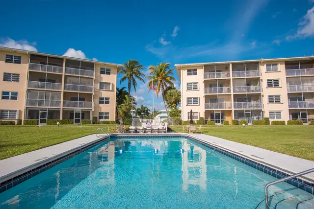 a house view with a swimming pool and sitting space
