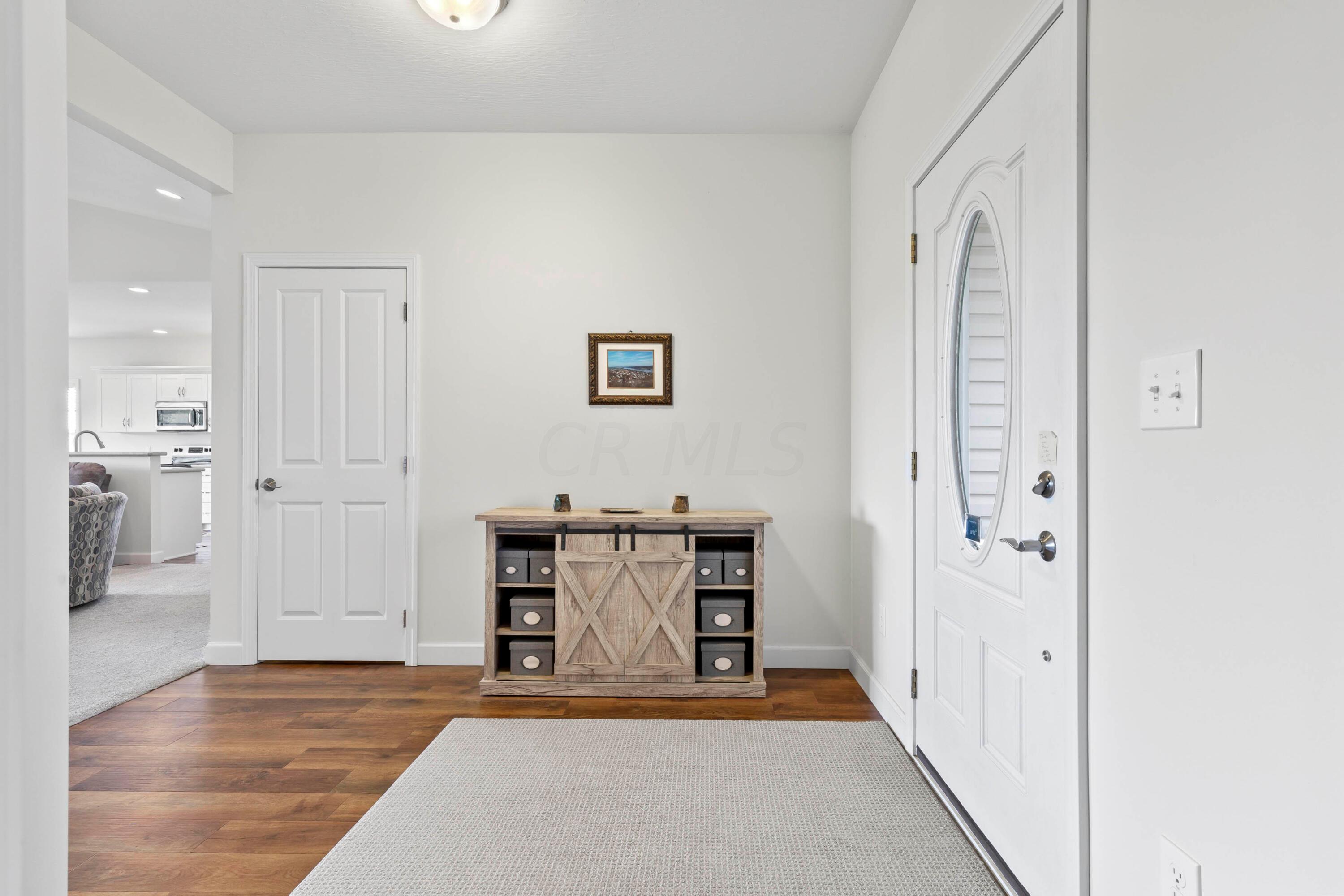 3644 Panhandle Road Delaware, OH 43015 - Photo 2 of 46 • High definition, “wood look”
laminate flooring
• Ivory painted walls
• Ceiling light
• Lighted storage closet
• Coat closet