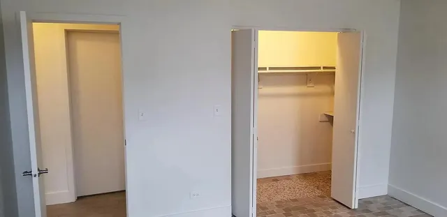 a view of an empty room with a closet