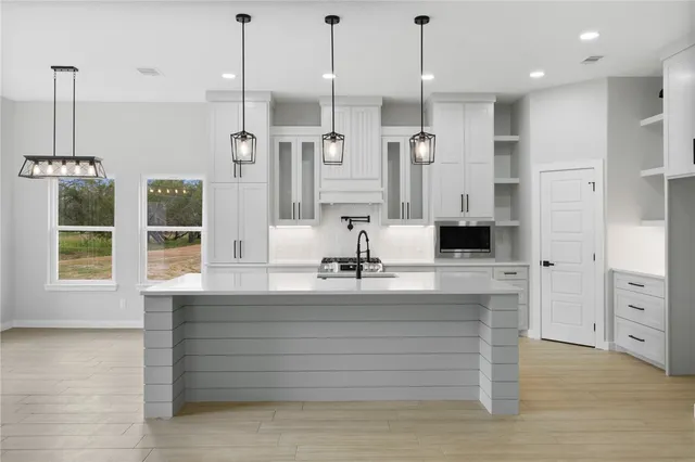 a bathroom with a double vanity sink a mirror and shower