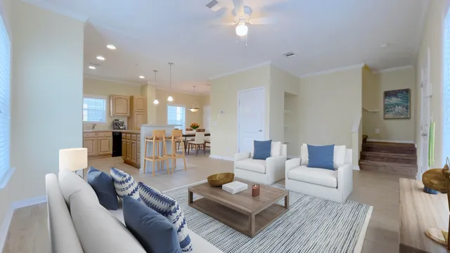 a living room with furniture and a view of kitchen