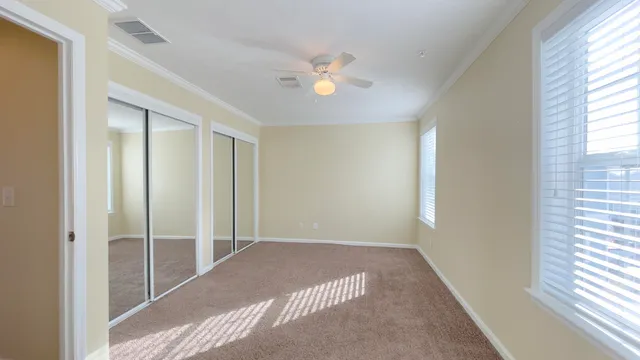 a view of a livingroom with a ceiling fan and window
